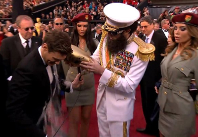 Sacha Baron Cohen To Ryan Seacrest: Sorry, I Meant To Throw The Ashes On Clooney!